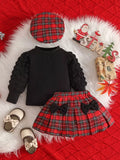 Black baby top with textured sleeves, red plaid skirt and matching plaid beret.