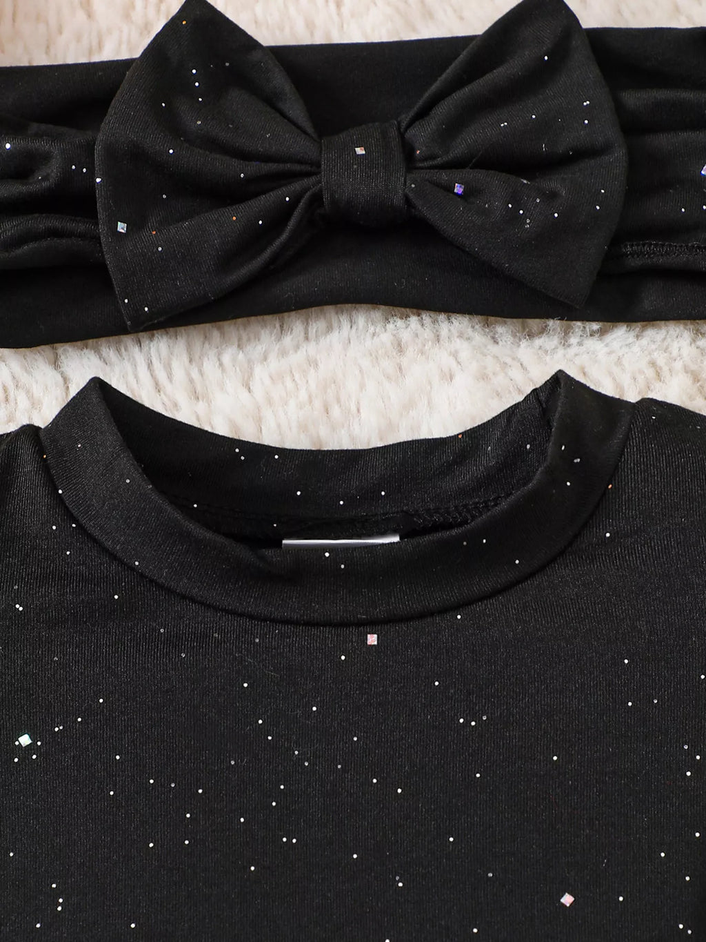 Black bow headband and bodysuit neckline detail