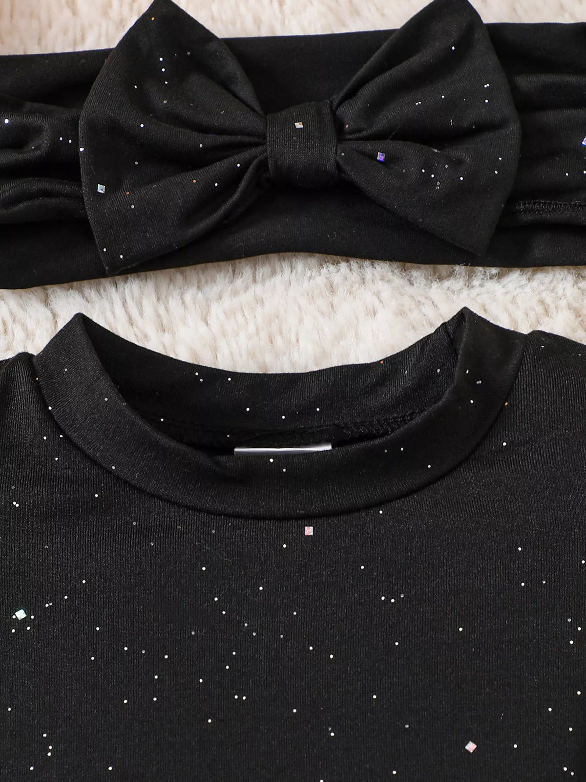 Black bow headband and bodysuit neckline detail