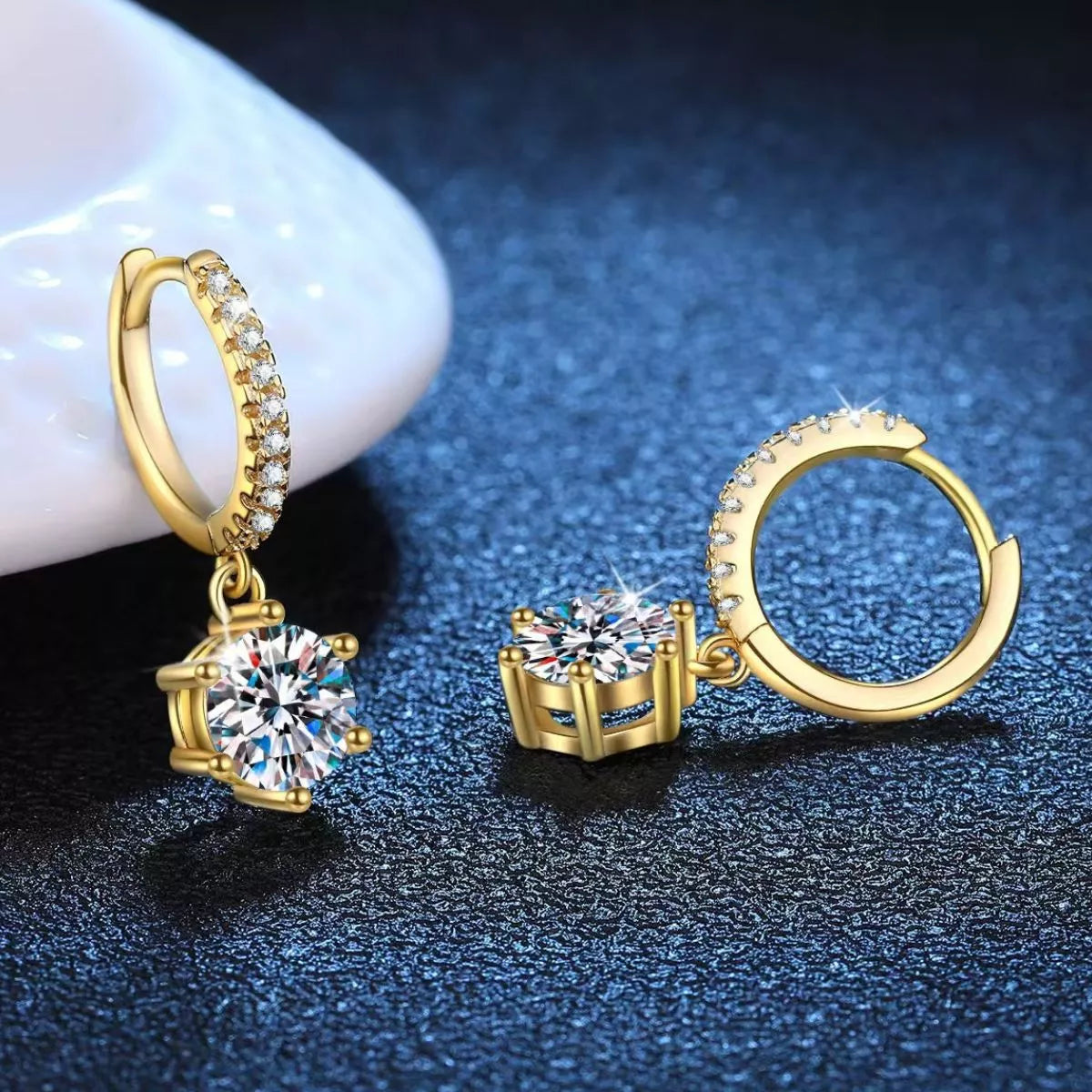 Gold-tone hoop earrings with round clear stone drops — detail view