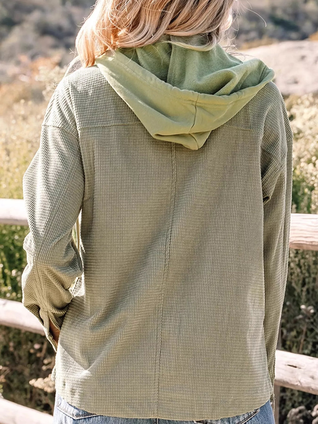 Back view of the matcha-green jacket and hood.