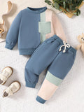 Blue, pink and mint color-block sweatshirt and matching joggers laid flat