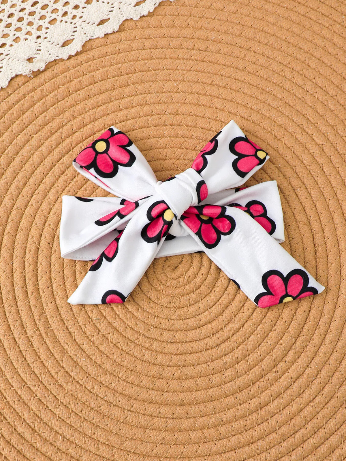 Matching white bow headband with pink flower print.