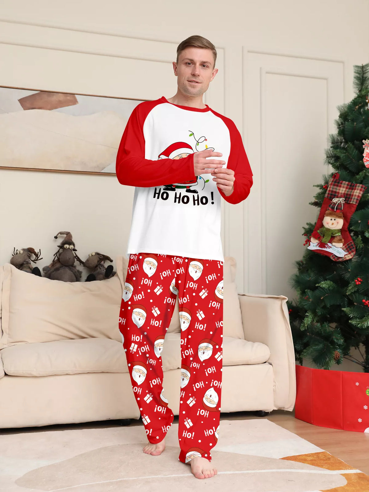 Man posing in the red-and-white Santa graphic pajamas.