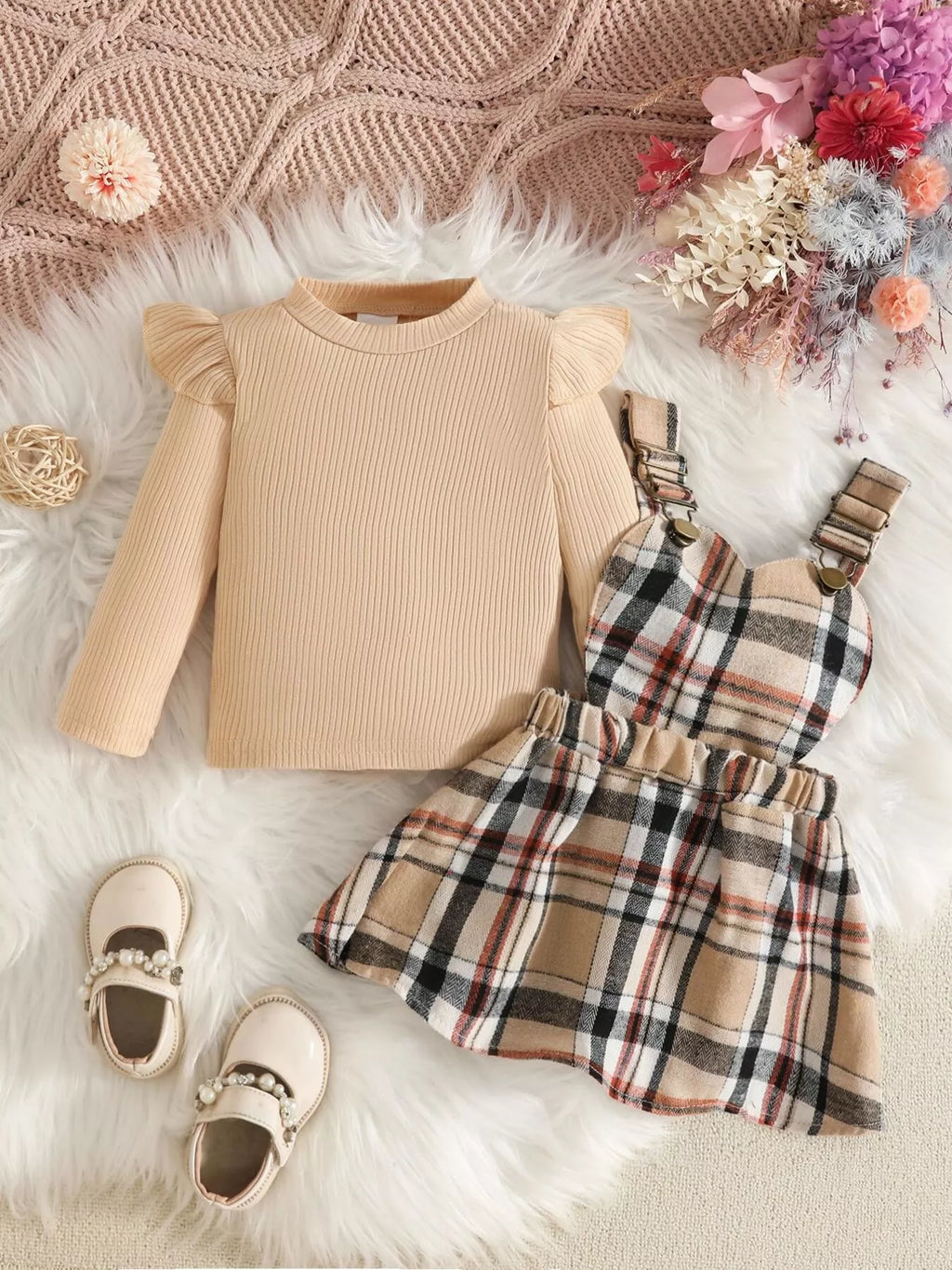 Cream long-sleeve top displayed beside the beige plaid suspender skirt.