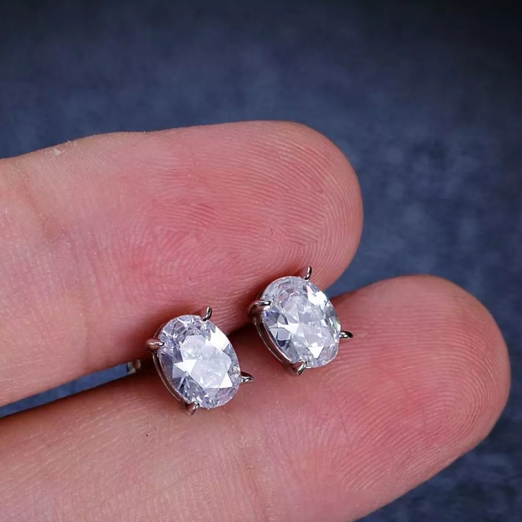 Silver-tone stud earrings with clear faceted stones — detail view