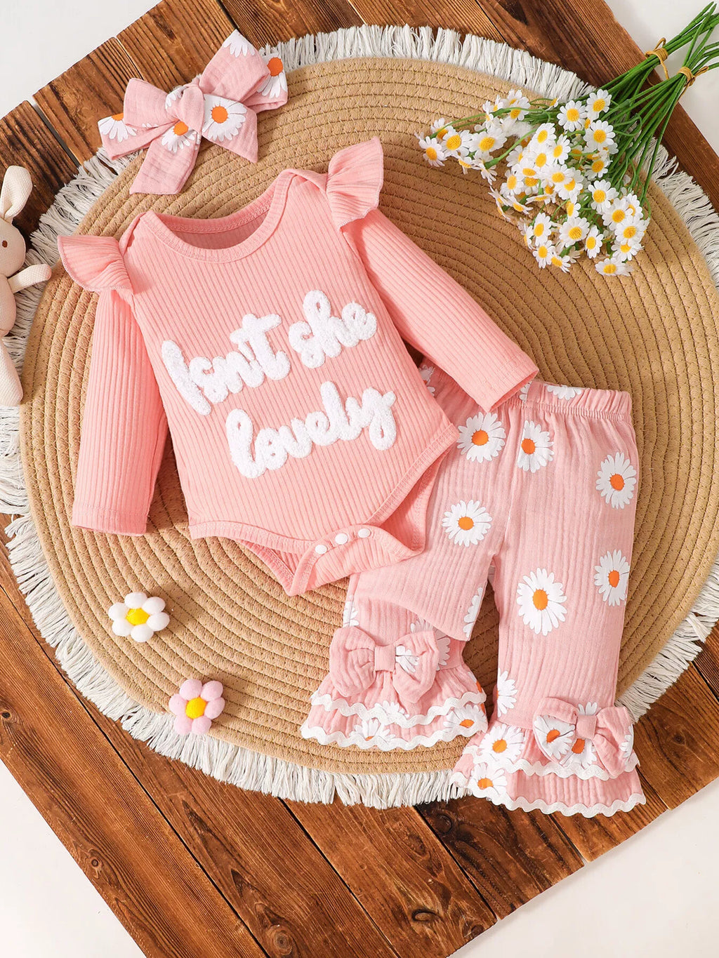 Pink Isn't She Lovely bodysuit with daisy-print ruffle pants and matching bow headband.