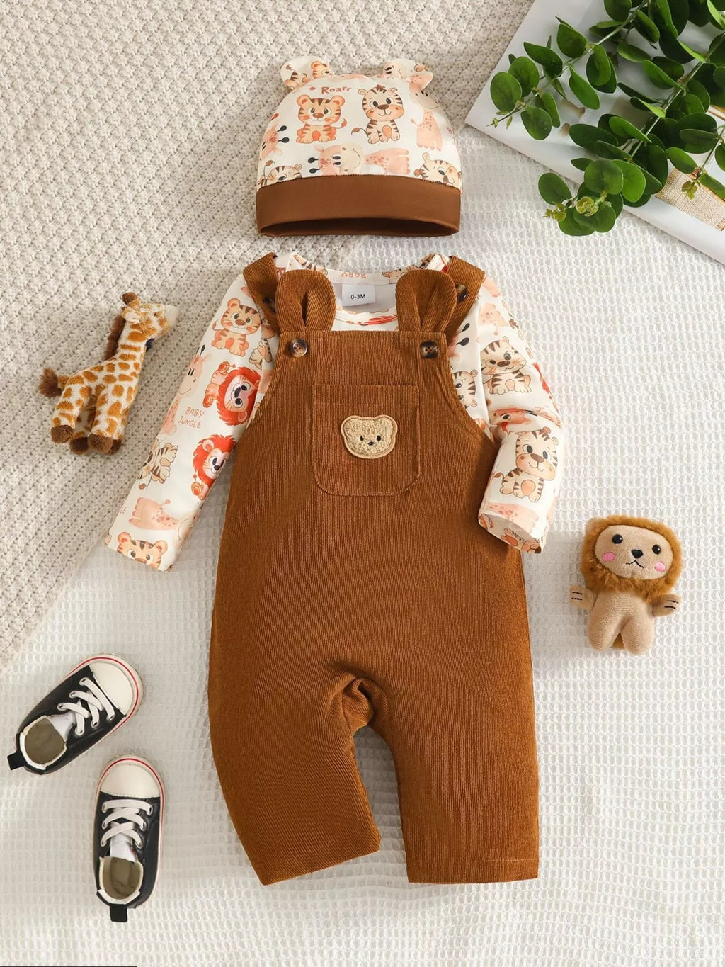 Brown corduroy overalls, animal-print long-sleeve top and matching hat displayed flat