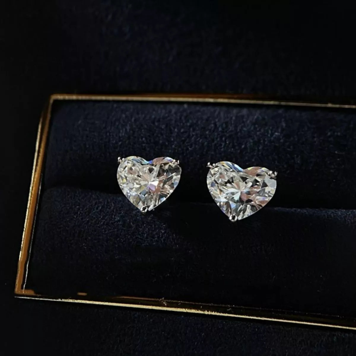 Silver-tone heart-shaped clear stone stud earrings — detail view