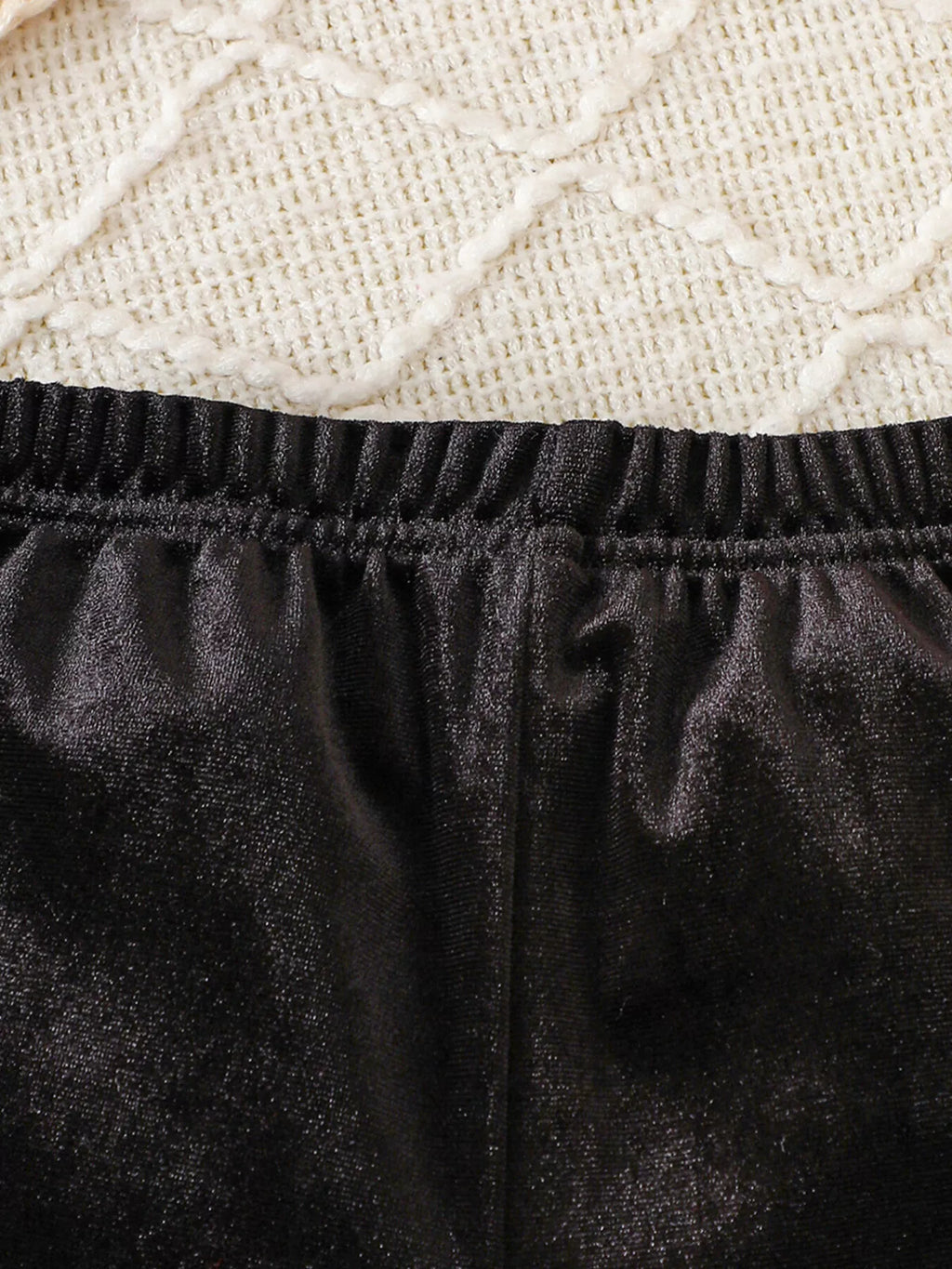 Close-up of the black pants' elastic waistband.
