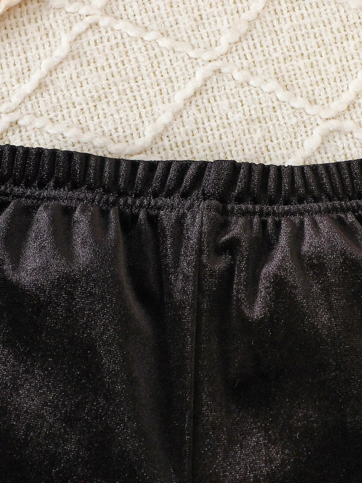 Close-up of the black pants' elastic waistband.