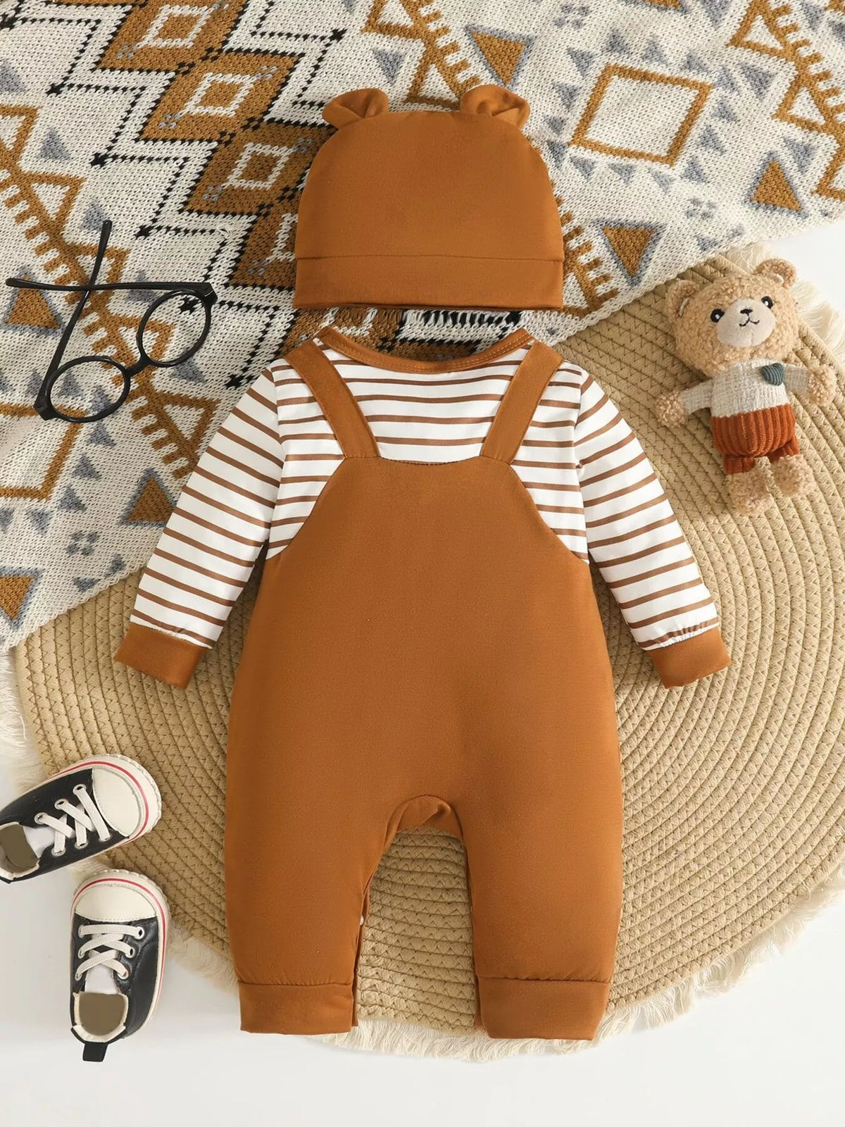 Children’s brown bear-print overalls with striped sleeves and matching hat displayed flat