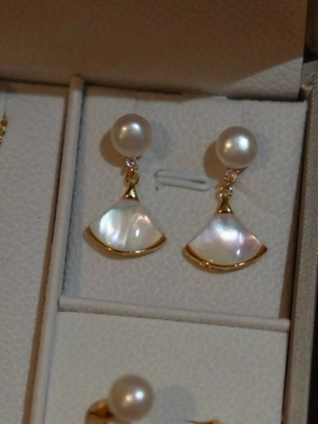 Fan-shaped drop earrings with pearl-like beads and gold-tone edges — detail view