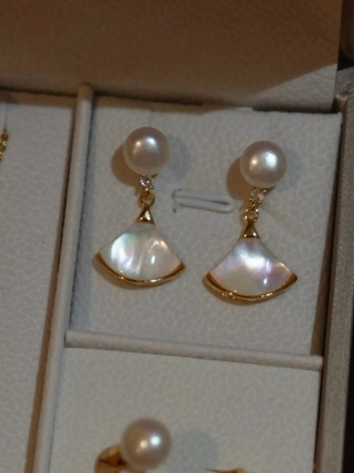Fan-shaped drop earrings with pearl-like beads and gold-tone edges — detail view