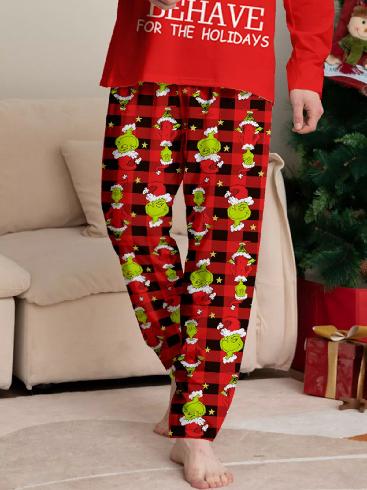 Festive Grinch-print fabric on the red pajama pants