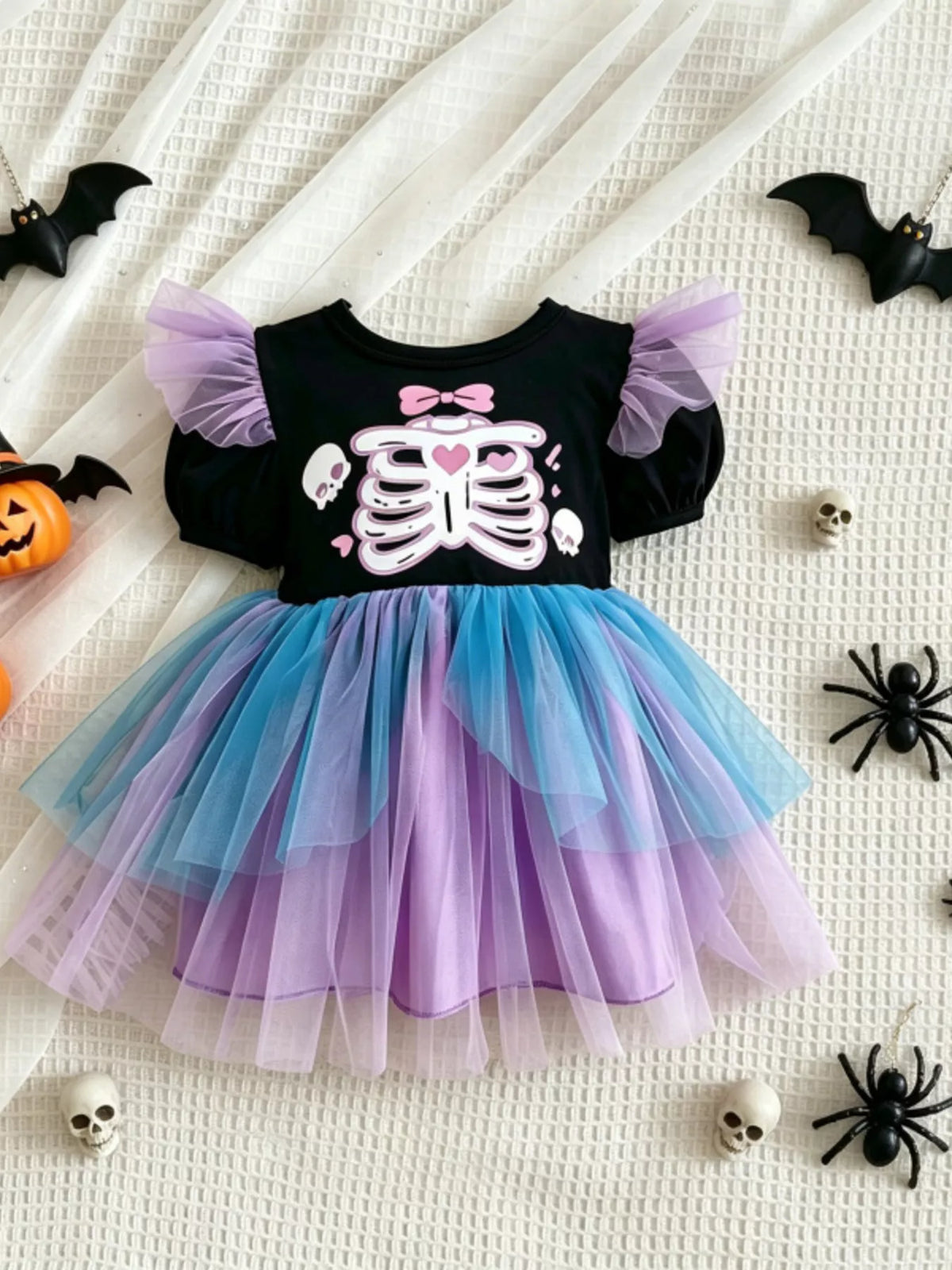 Flat lay of the black skeleton bodice dress with layered blue and purple tulle.