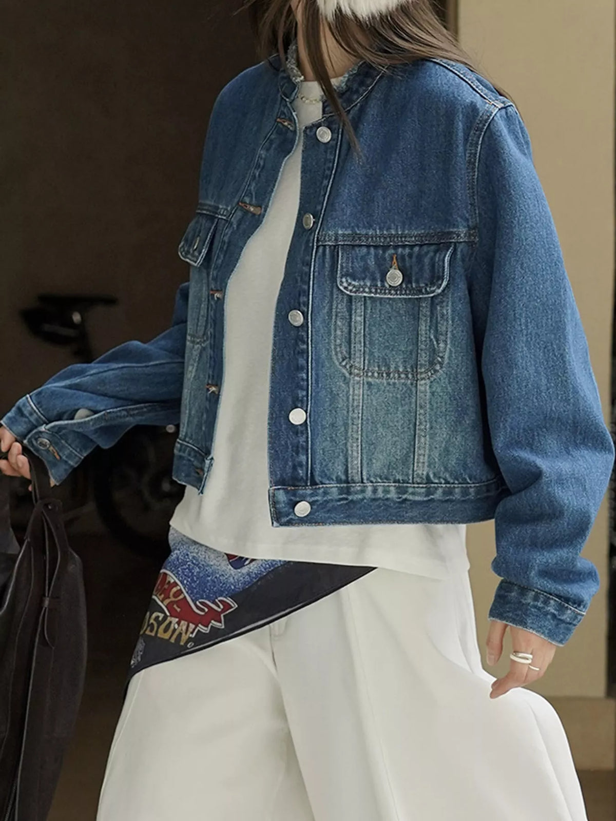Front view of the blue denim jacket worn open.