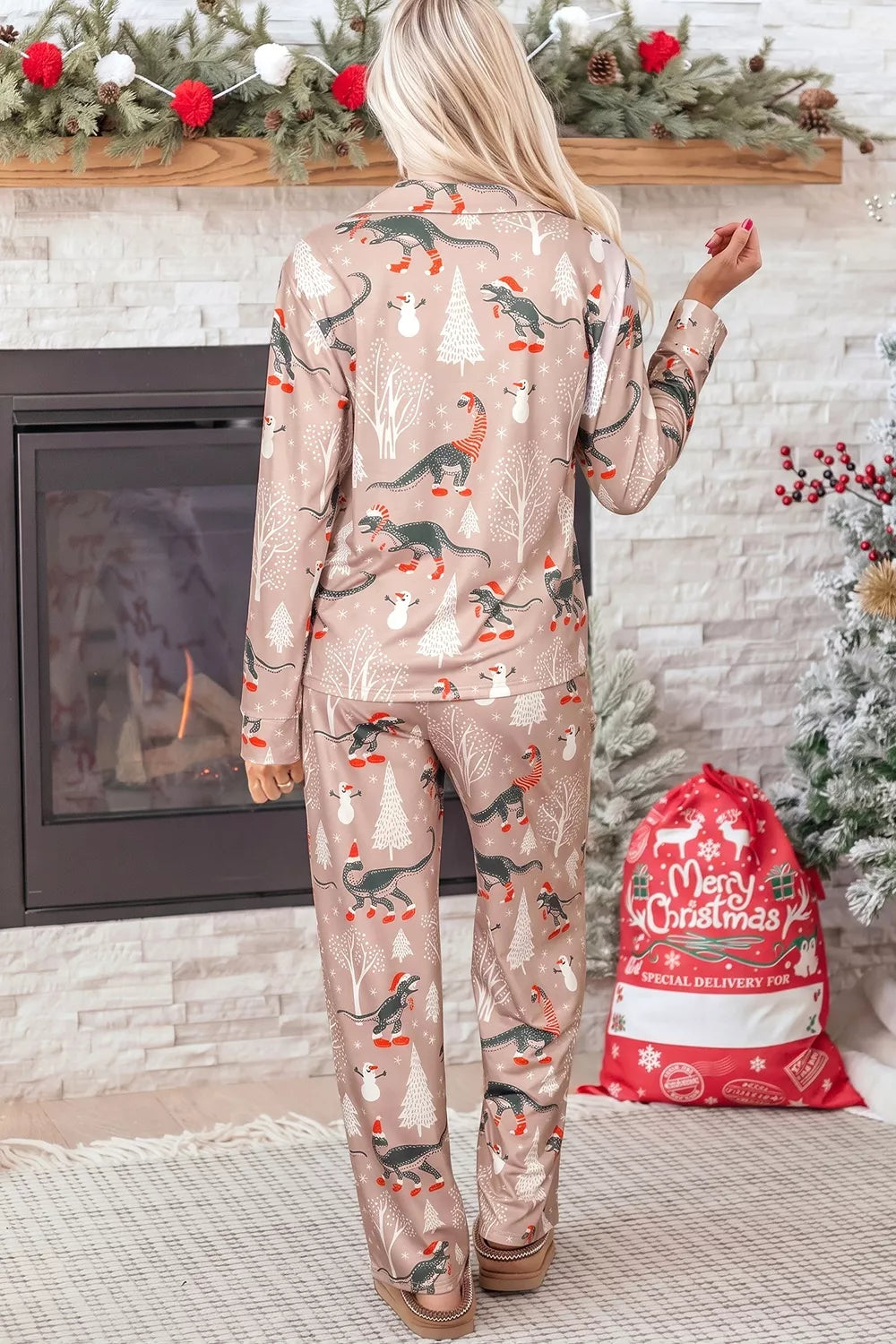 Pink long-sleeve pajama shirt and pants with dinosaur Christmas print — back view