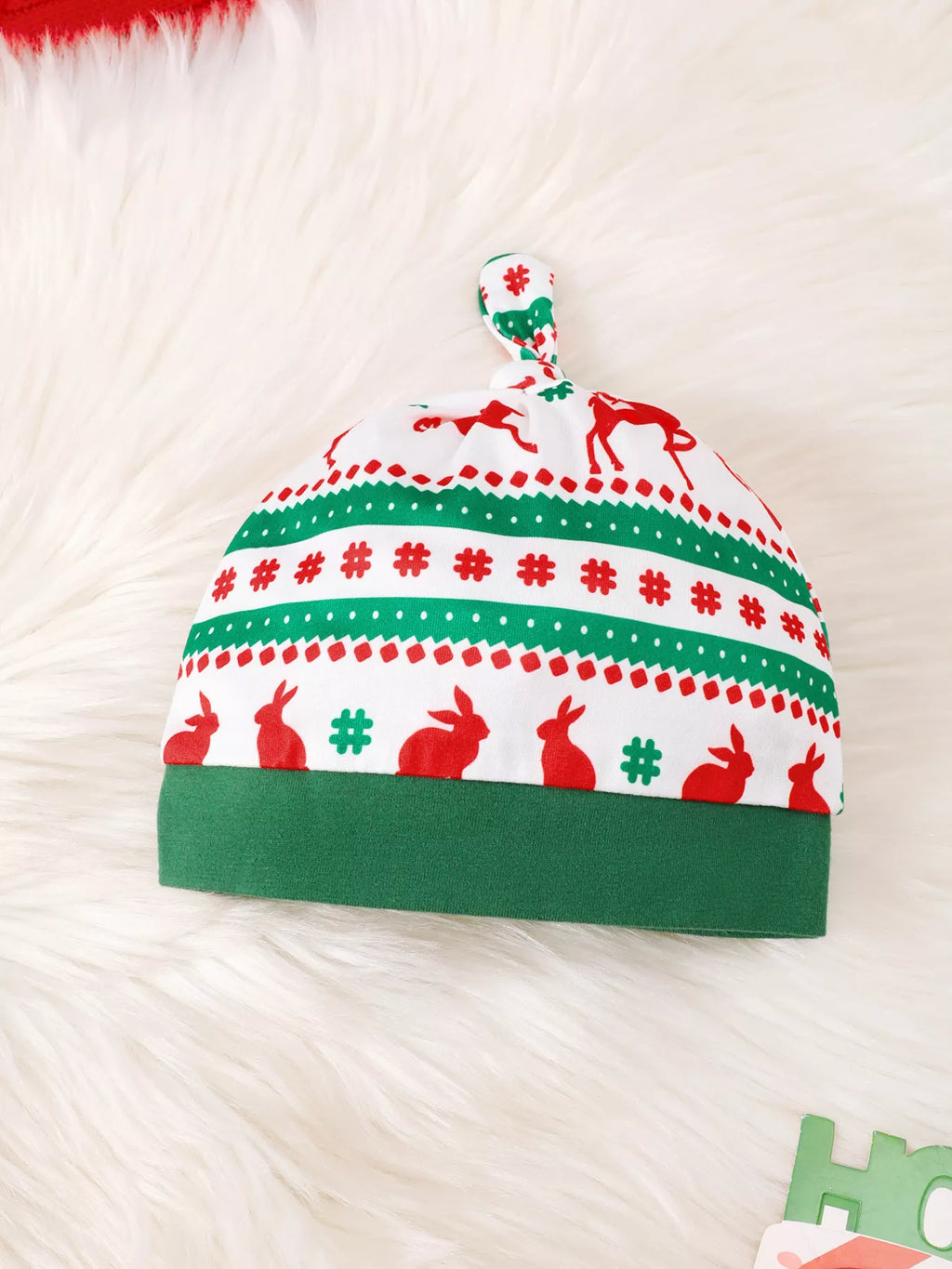 Matching green, red and white Christmas-patterned baby hat.