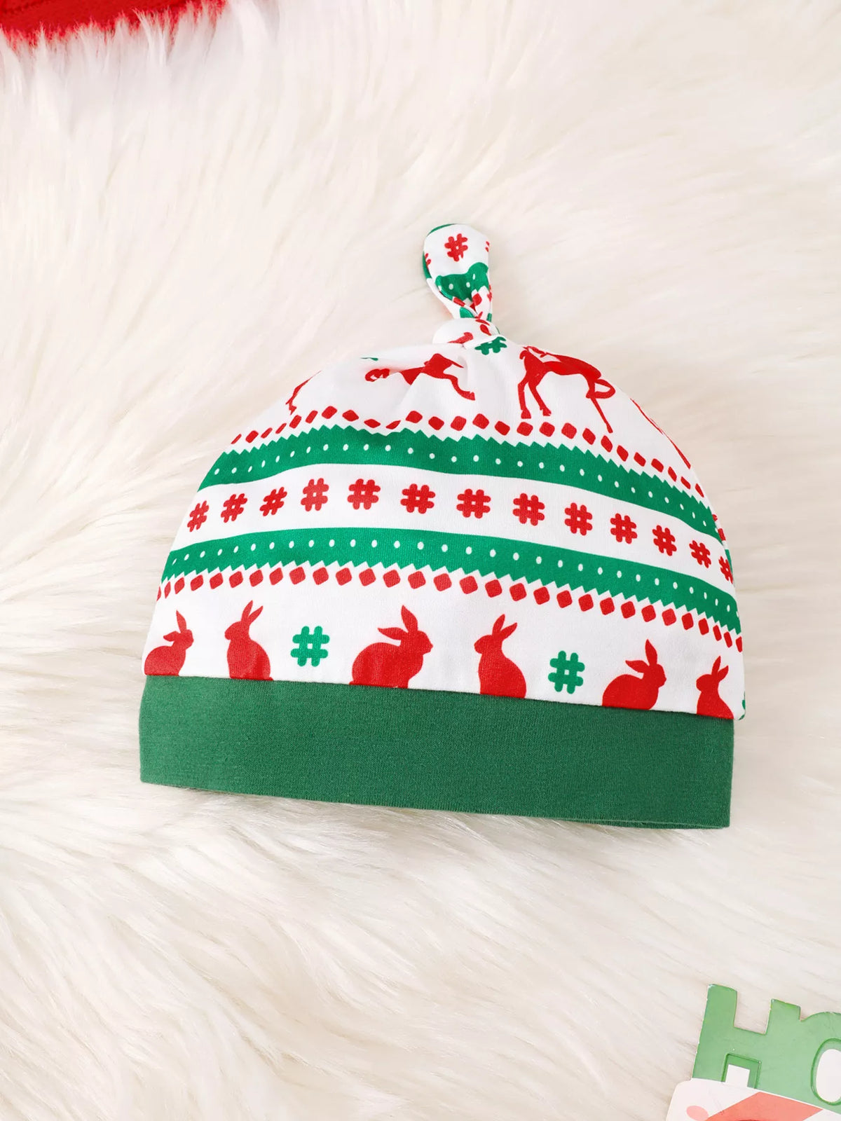 Matching green, red and white Christmas-patterned baby hat.