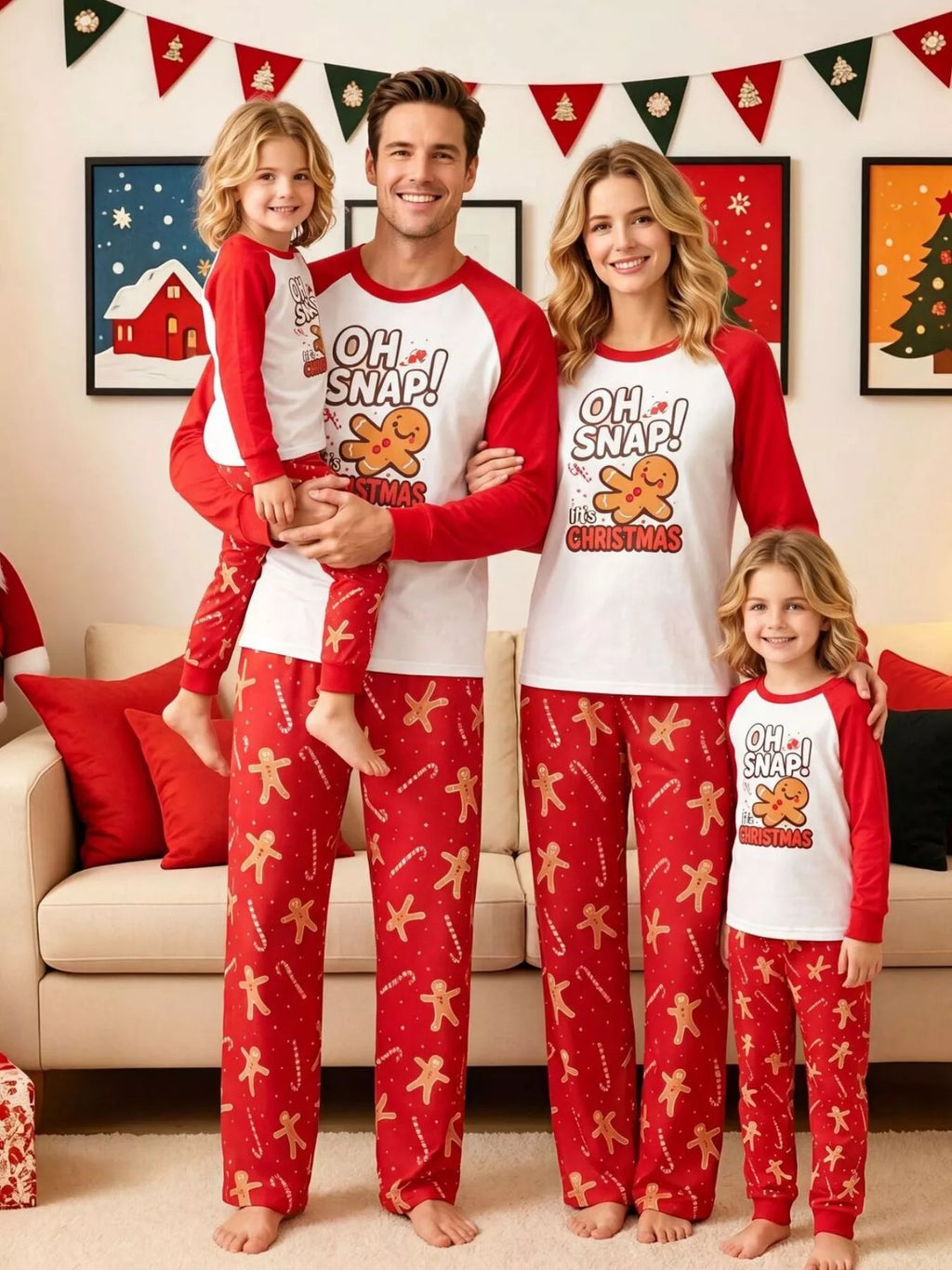 Family wearing matching white Oh Snap gingerbread graphic tops with red sleeves and red printed pajama pants.