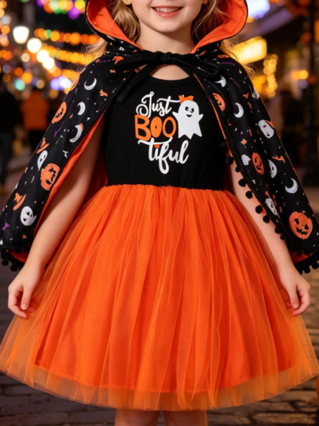 Black Just BOO tiful graphic dress with orange tulle skirt and Halloween-print hooded cape worn by a child