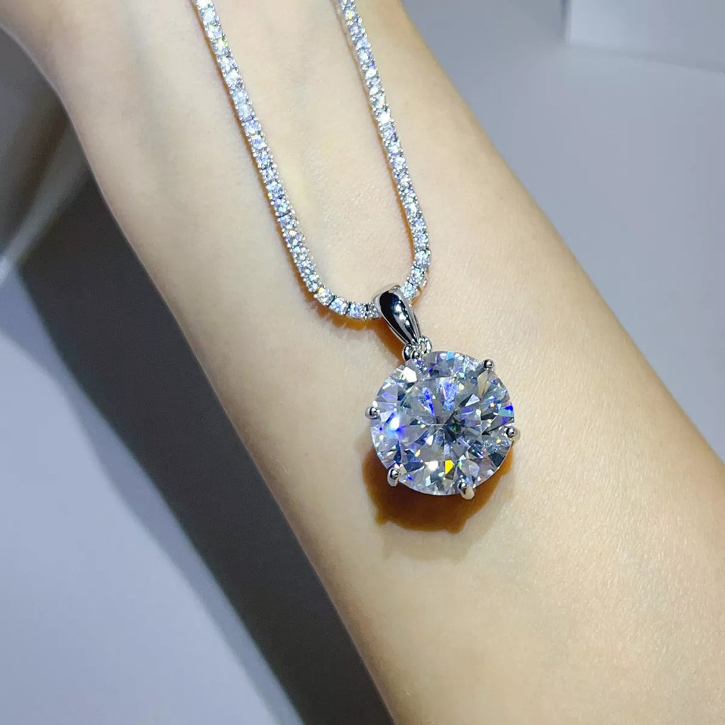 Silver-tone necklace with a round clear stone pendant — detail view