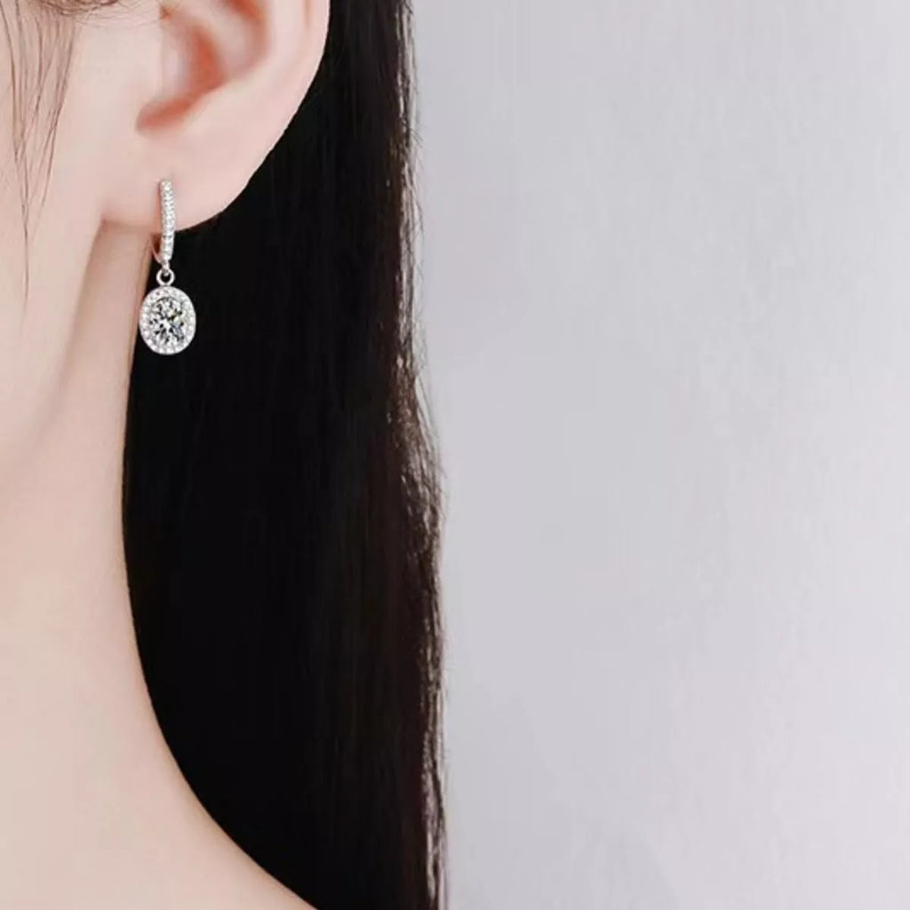 Silver-tone hoop earrings with oval halo stone drops — detail view