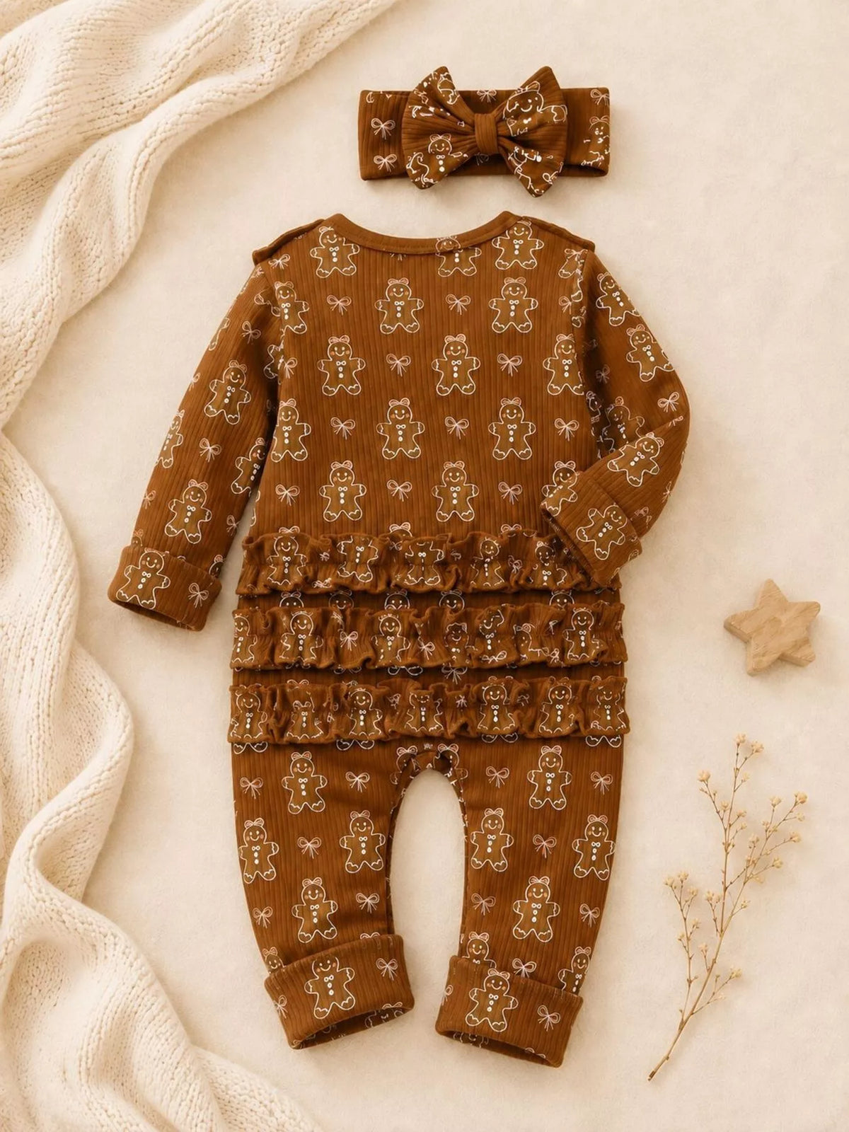 Back flat lay of the brown gingerbread-print romper and matching bow headband.