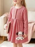Child wearing a red fine-striped long-sleeve dress with a puppy applique.