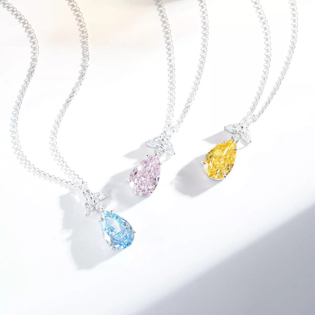 Pink, yellow and blue teardrop pendant necklaces displayed together