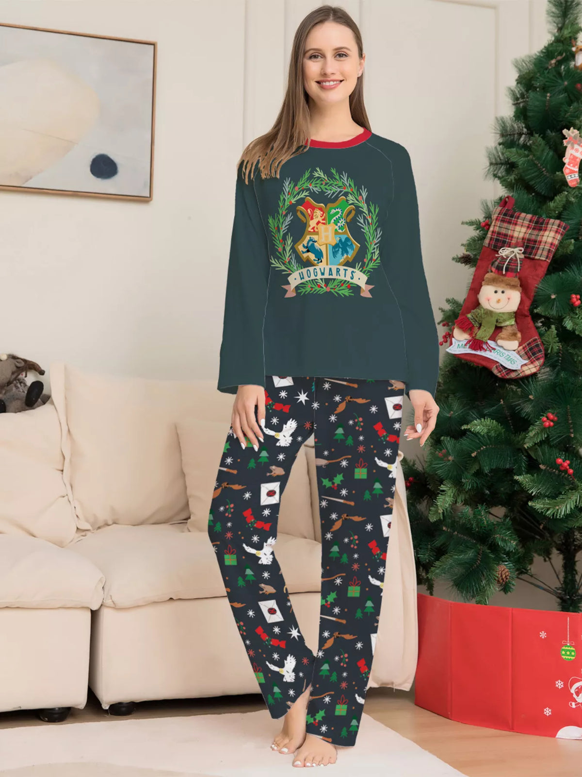 Dark green Hogwarts graphic pajama top with black patterned pants worn by an adult