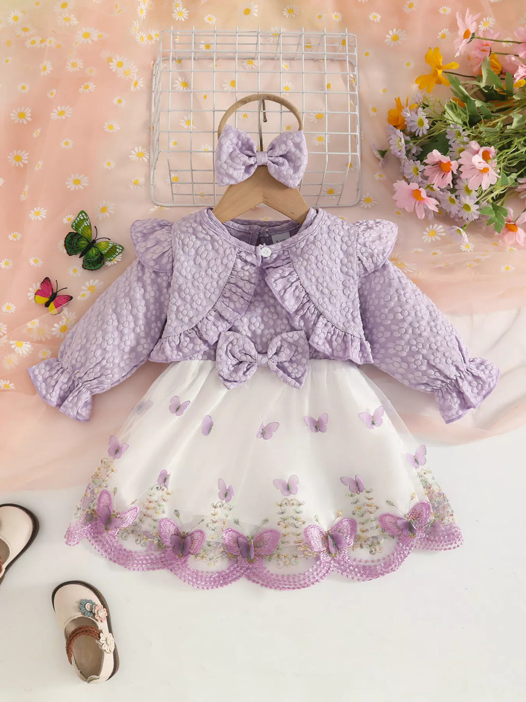 Lavender baby jacket displayed on a hanger above the coordinating vest and tulle skirt.