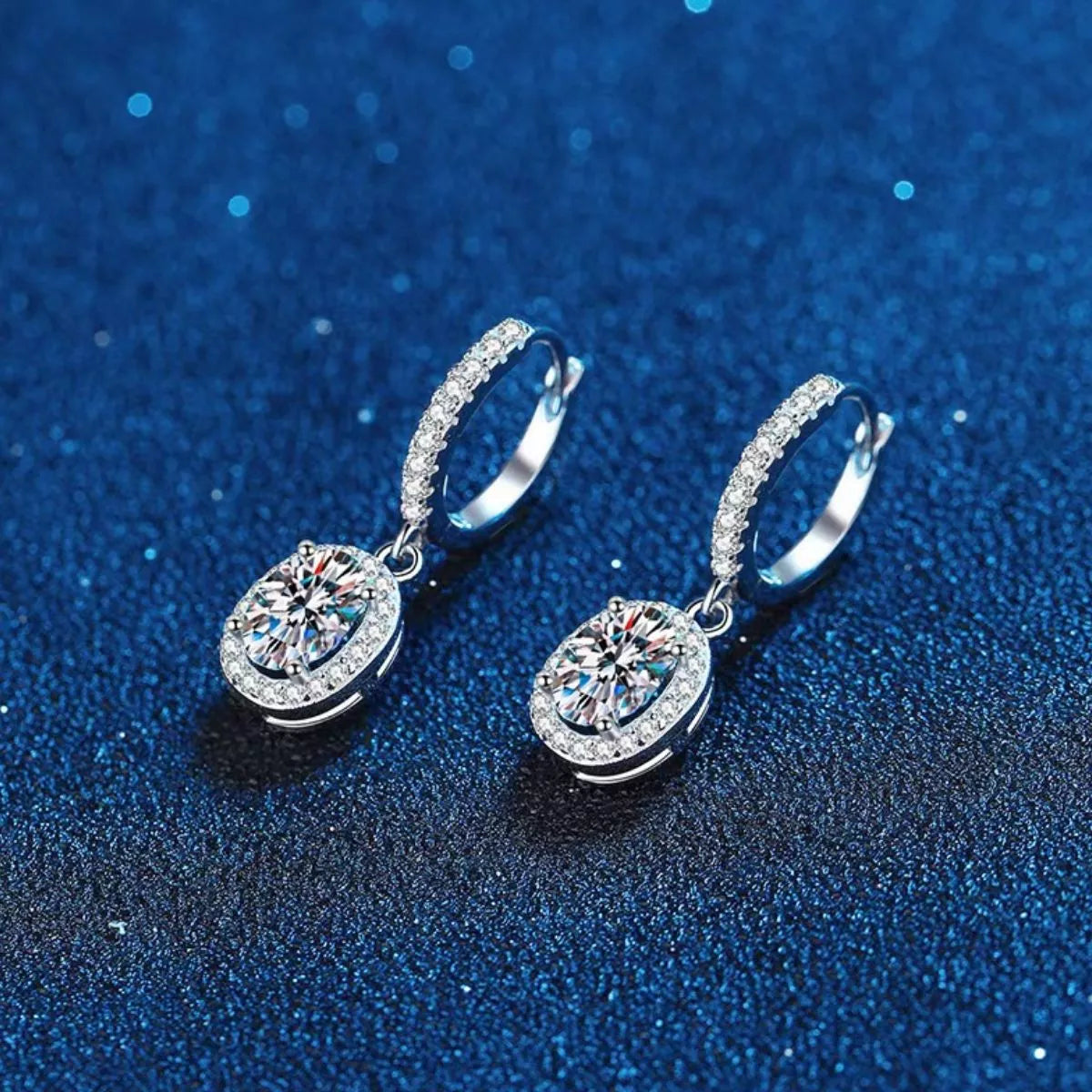 Silver-tone hoop earrings with oval halo stone drops — detail view