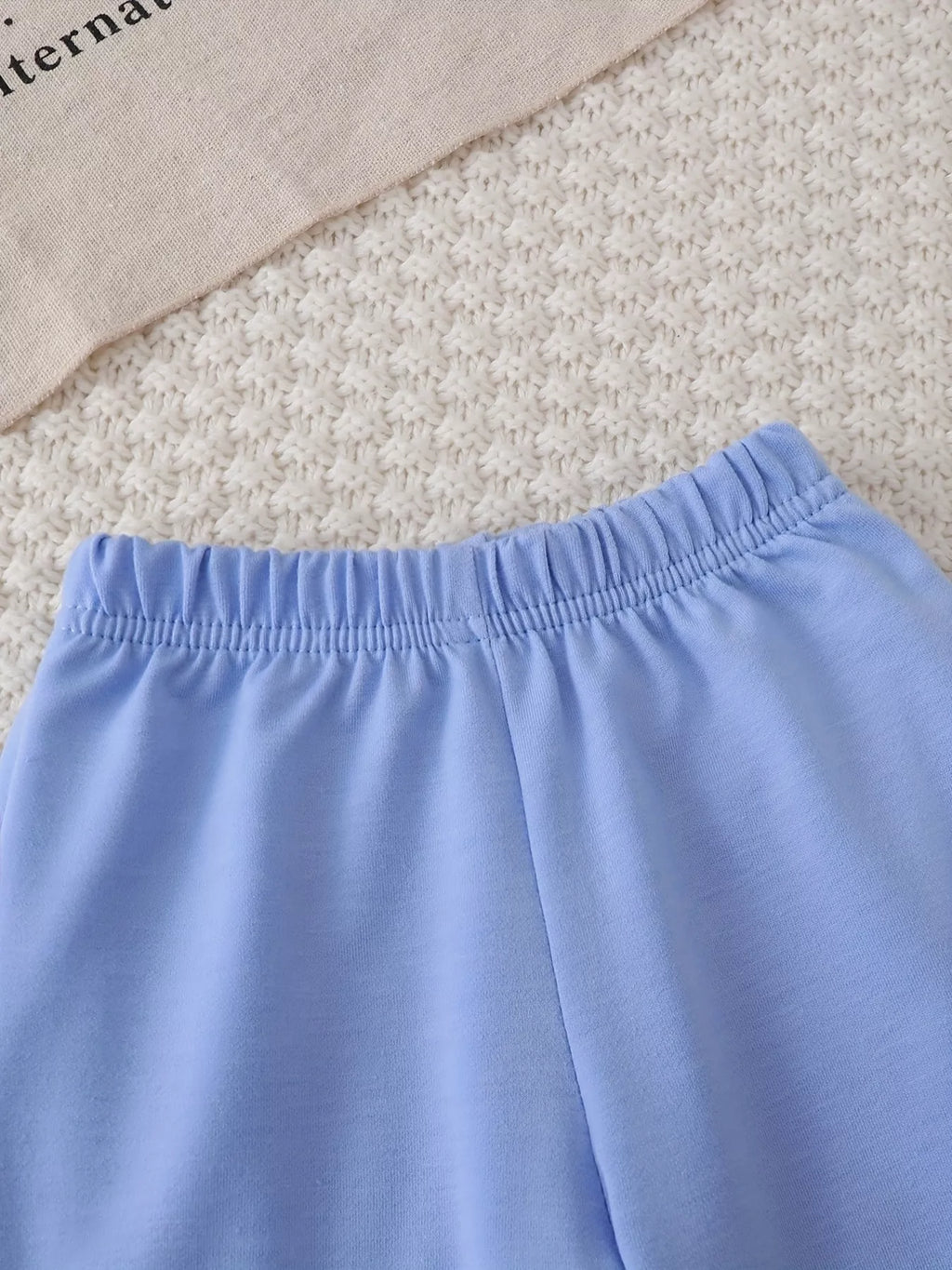 Close-up of the light blue pants' elastic waistband.
