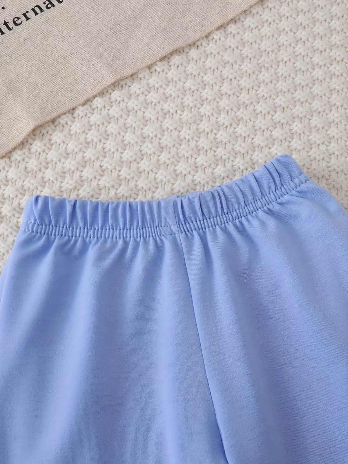 Close-up of the light blue pants' elastic waistband.