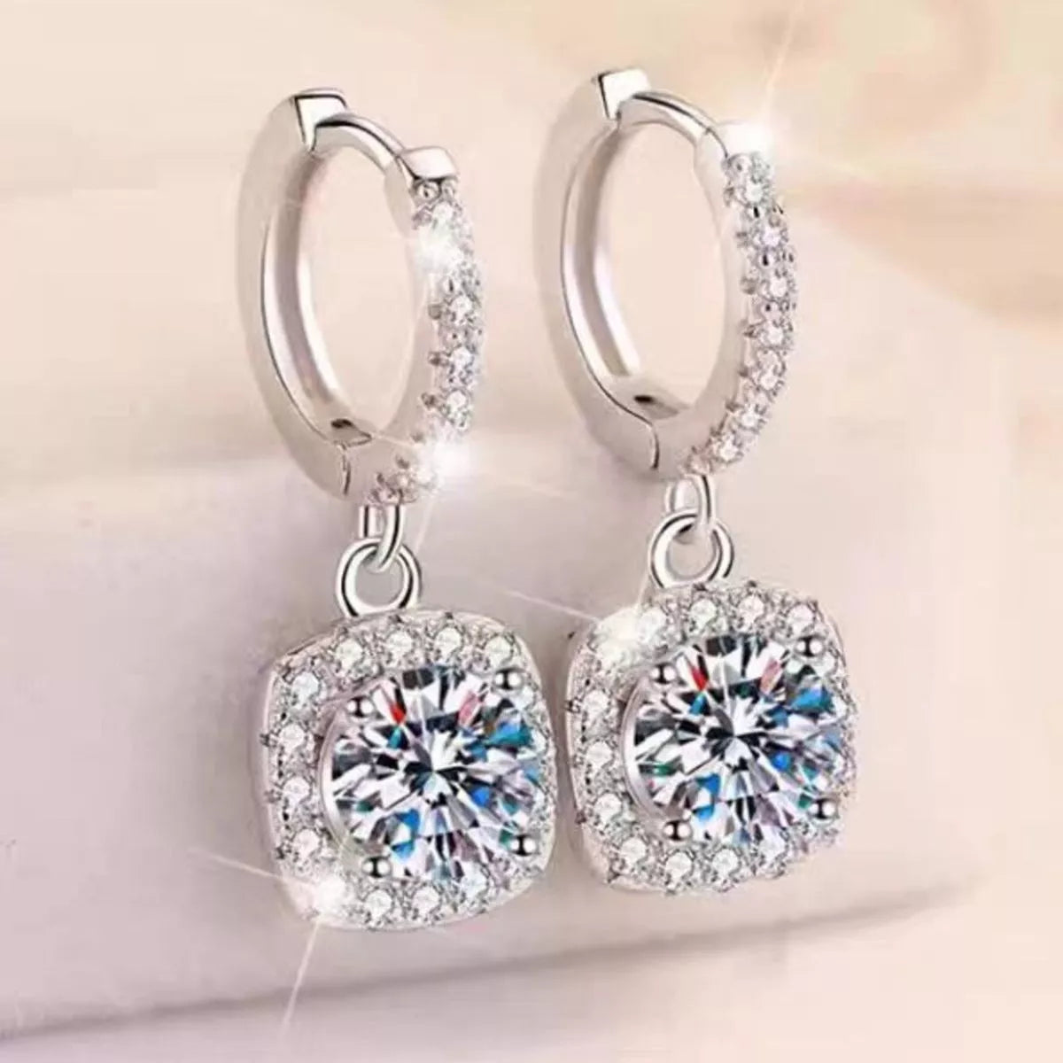 Silver-tone hoop earrings with square halo stone drops — detail view