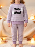Purple striped ghost graphic pajama top and matching pants worn by a child