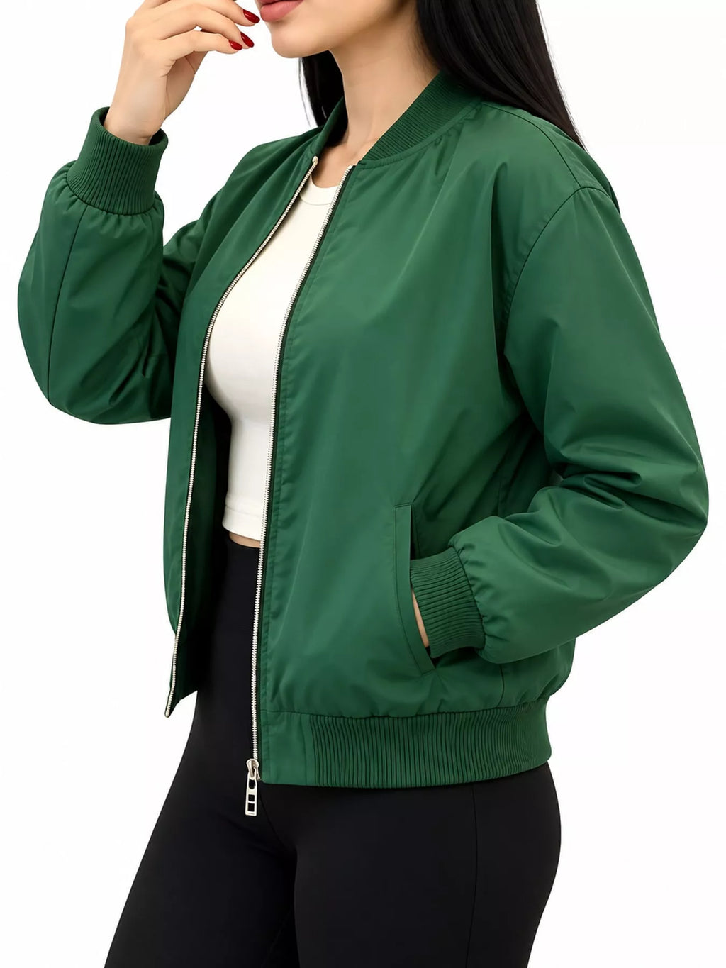 Green bomber jacket modeled with a hand in the pocket.