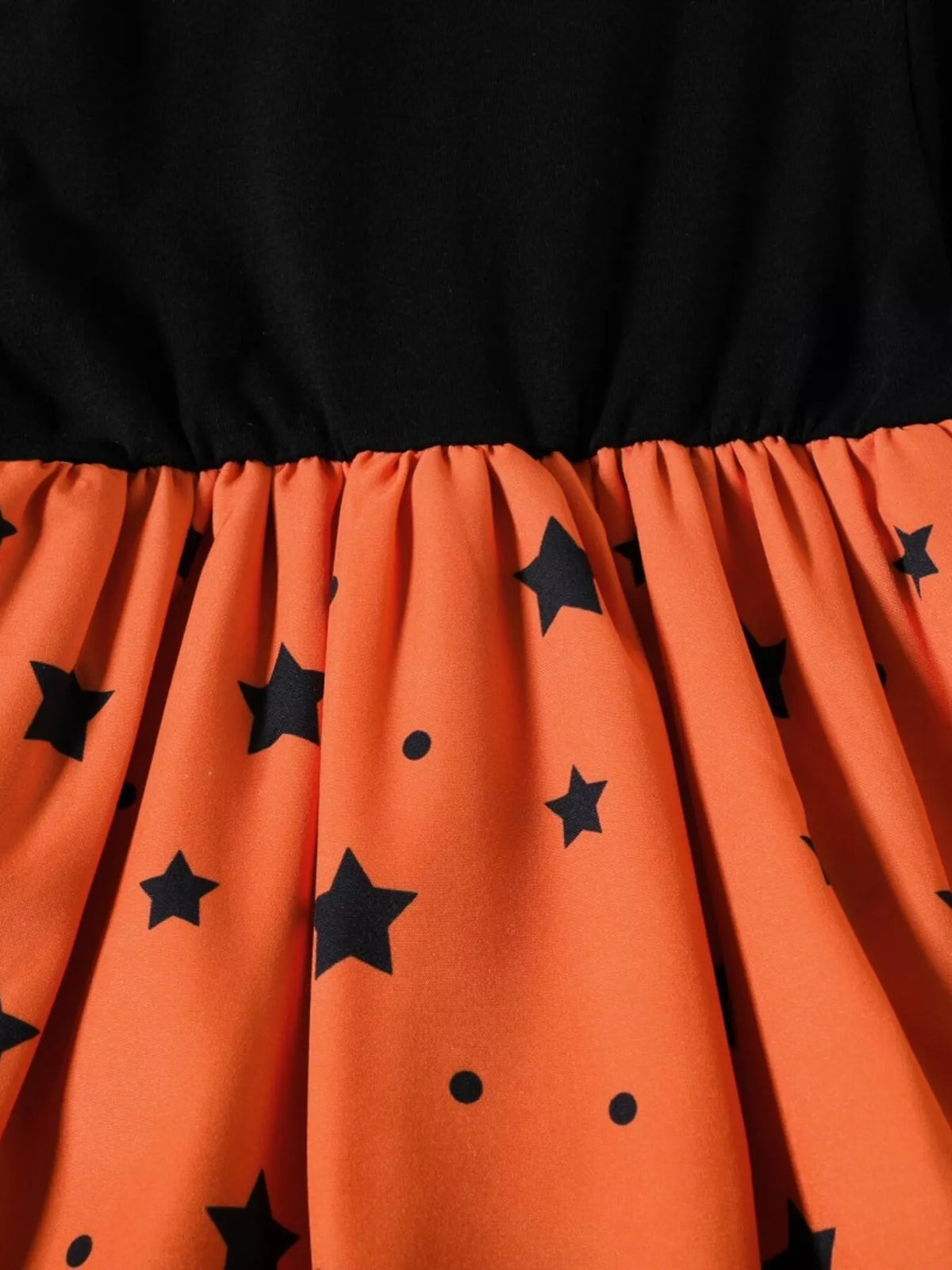 Gathered waist and black star pattern on the orange dress skirt