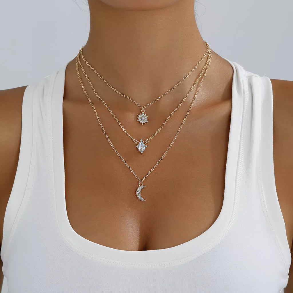 Layered silver-tone necklace with celestial and clear stone charms