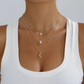 Layered silver-tone necklace with celestial and clear stone charms