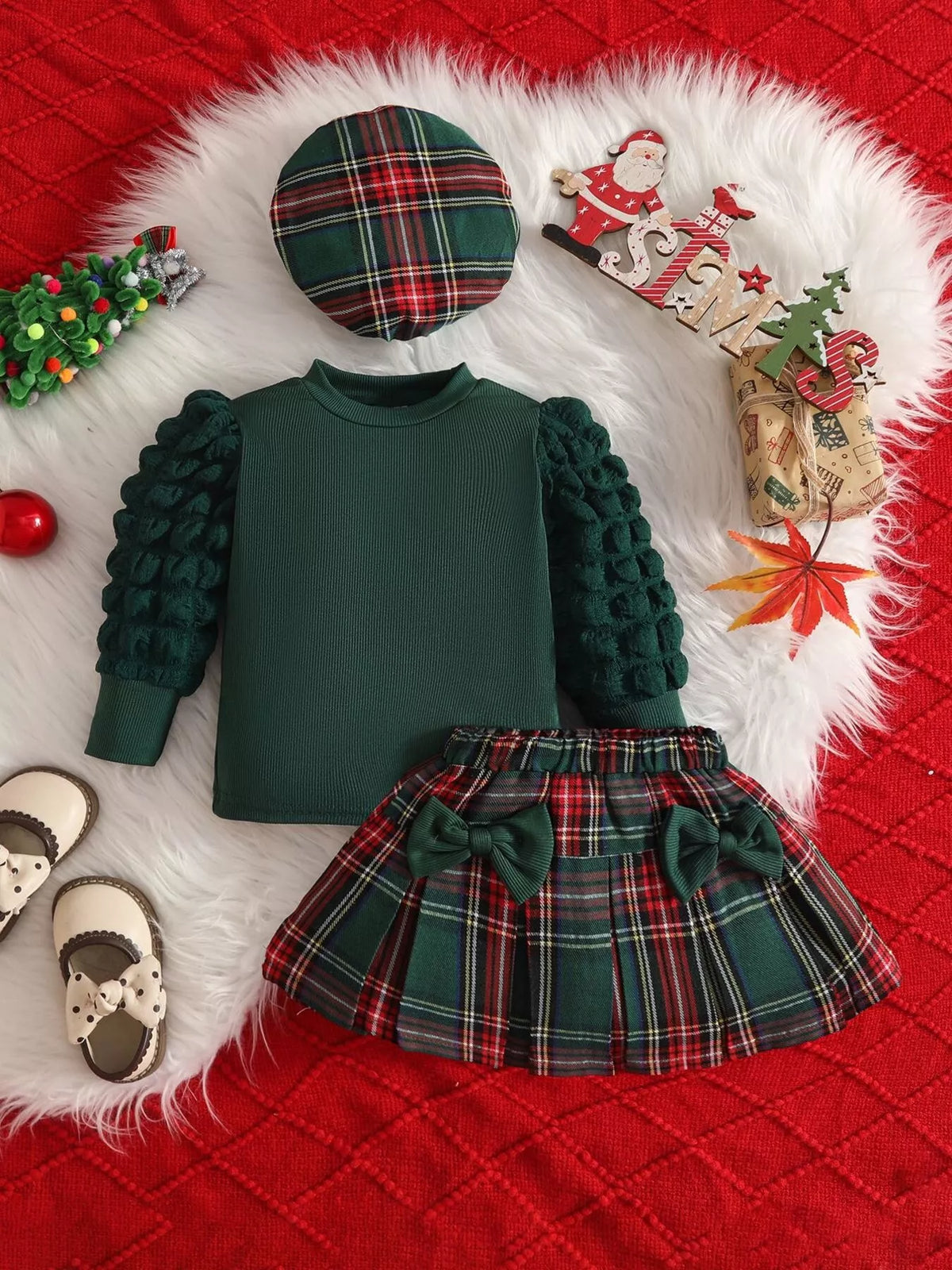 Green baby top with textured sleeves, green plaid skirt and matching plaid beret.
