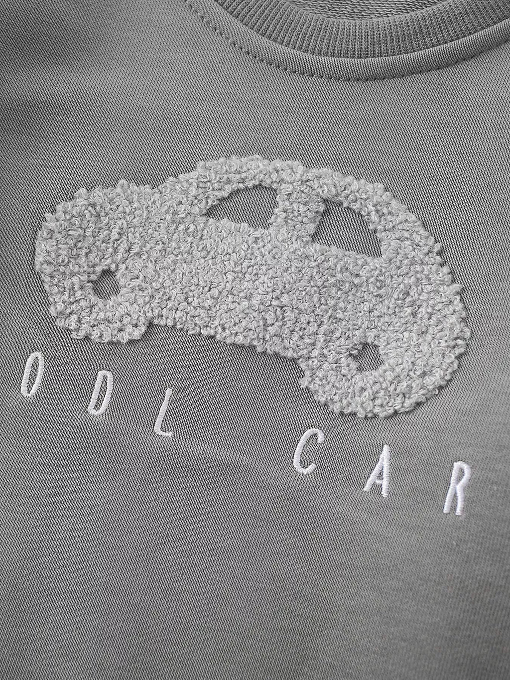 Close-up of the textured light gray car applique and Cool Car lettering.