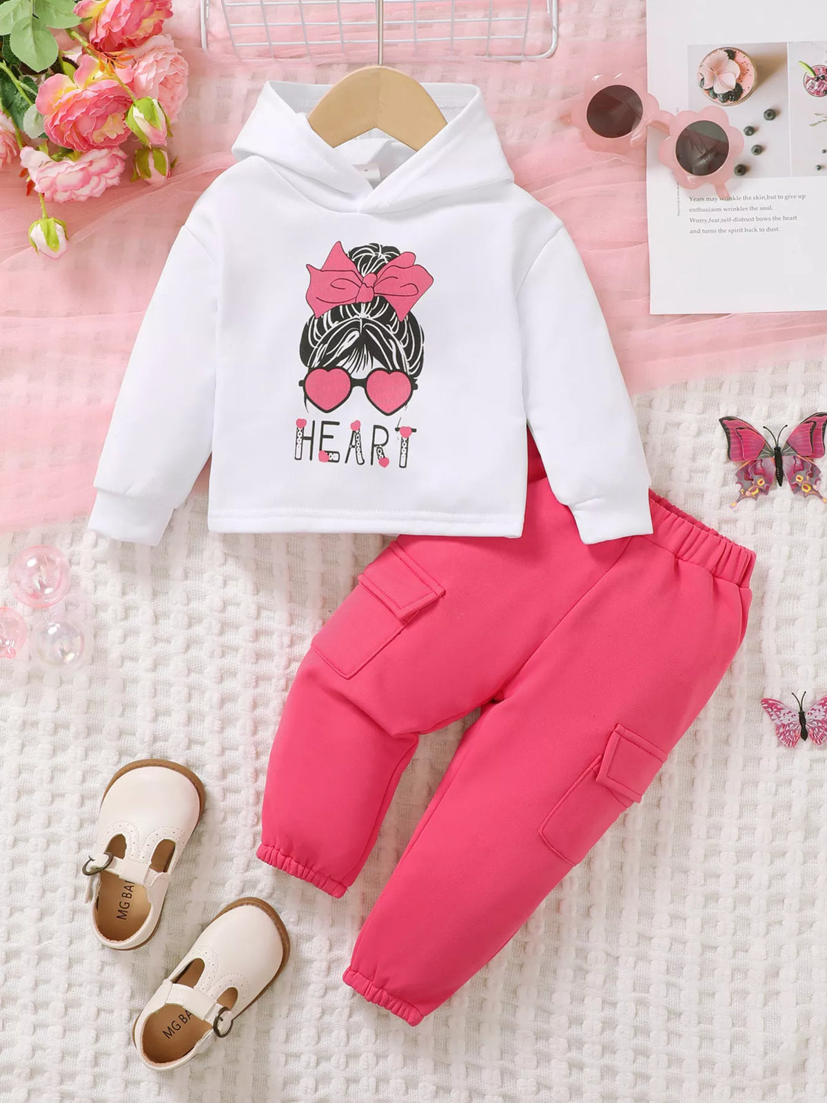 Children’s white graphic hoodie and pink cargo pants displayed flat