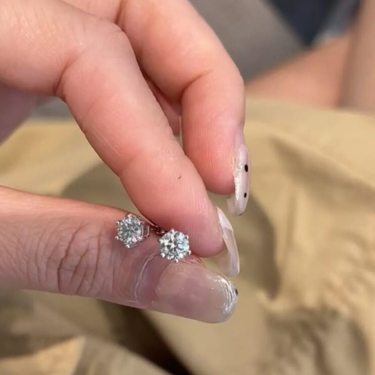Silver-tone round clear stone stud earrings — detail view