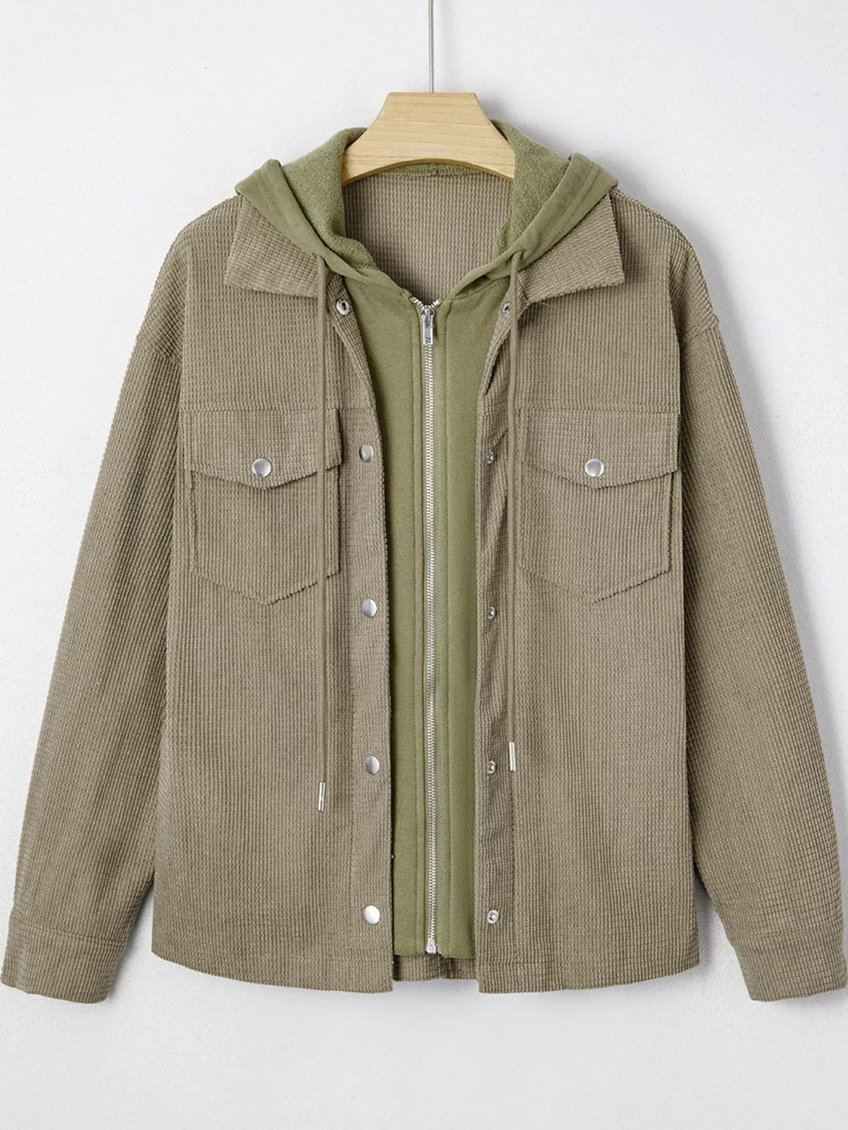 Matcha-green textured hooded jacket displayed on a hanger.