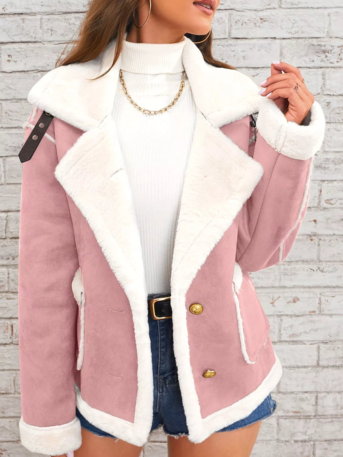 Pink jacket with wide white plush lapels, contrast trim and front pockets, front view modeled holding the lapel.