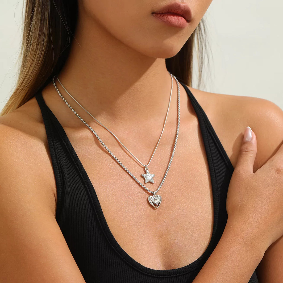 Layered silver-tone star and heart pendant necklaces