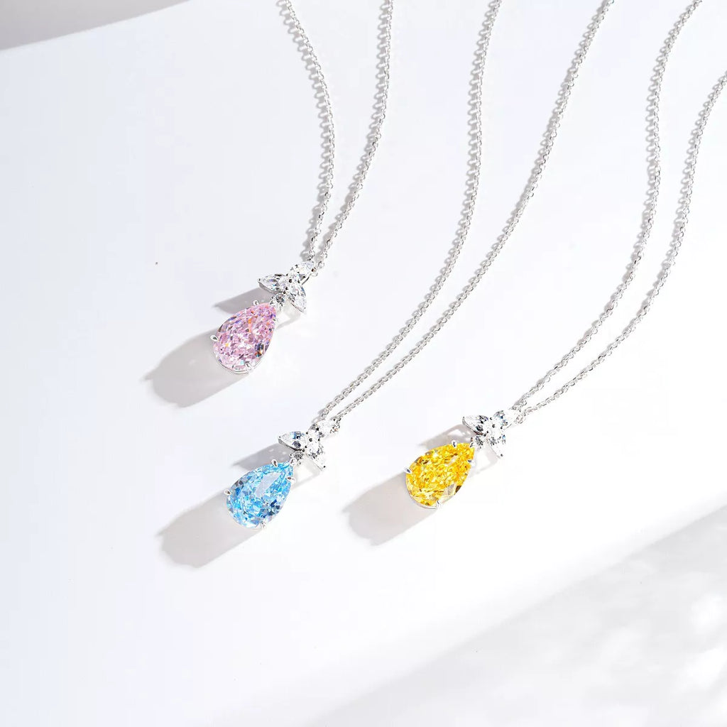 Pink, yellow and blue teardrop pendant necklaces displayed together
